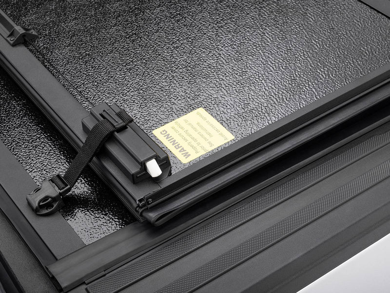 Close-up of the folded Gator EFX hard panels with the strap and the warning label on the panel