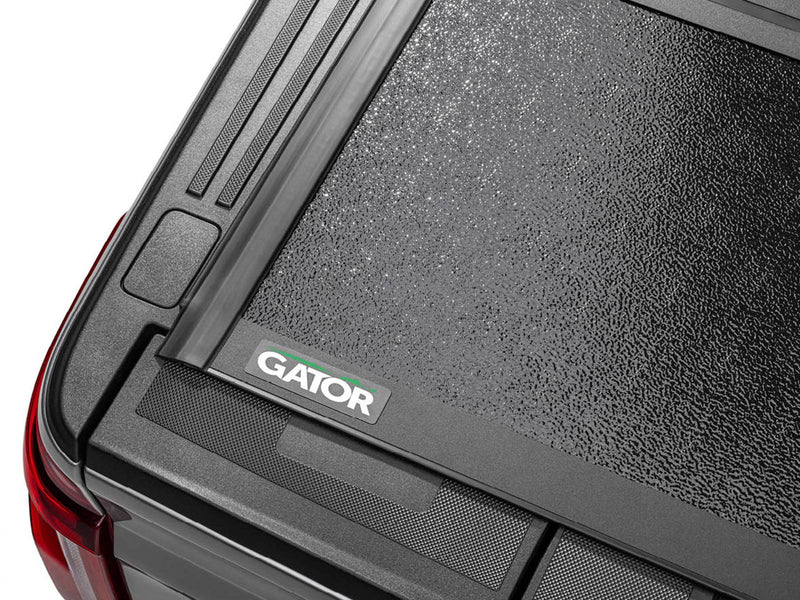 Close-up of the Gator EFX tonneau cover: close-up of the rear corner of a closed hard folding cover with the Gator logo plate