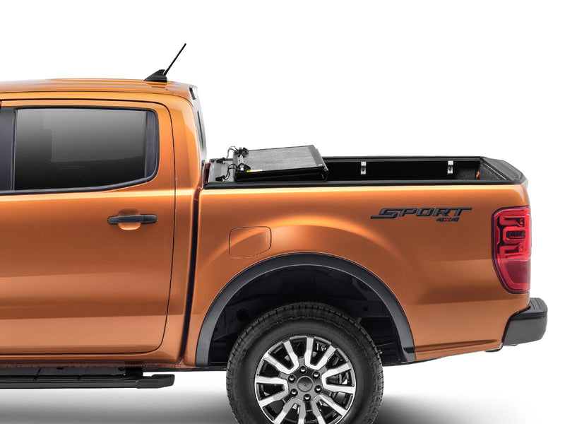 Gator EFX hard folding tonneau cover: Side view of an orange Ford Ranger with the hard tri-fold cover folded toward the cab