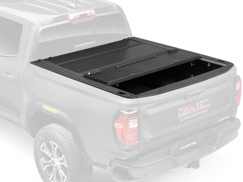 Gator FX tonneau cover: ghosted render of a GMC Canyon with the rear section of a black hard folding cover folded forward