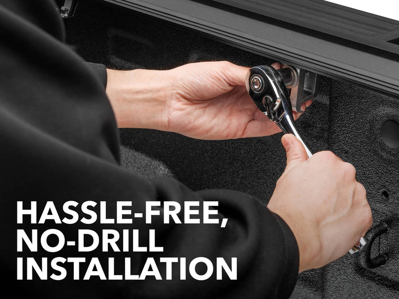 Close-up of the Gator FX tonneau cover: hands tightening a cover clamp with a ratchet inside a truck bed, captioned Hassle-Free, No-Drill Installation