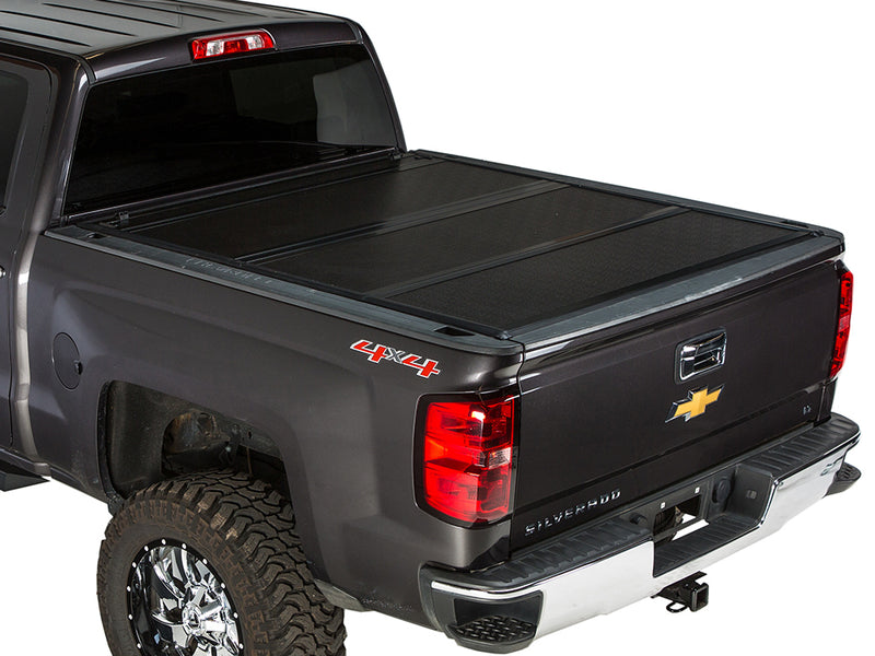 Gator FX hard folding tonneau cover: closed on a dark gray Chevrolet pickup, rear three-quarter view