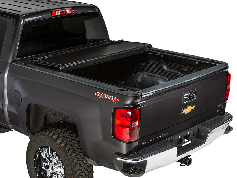 Gator FX hard folding tonneau cover: rear panel folded forward on a dark gray Chevrolet pickup