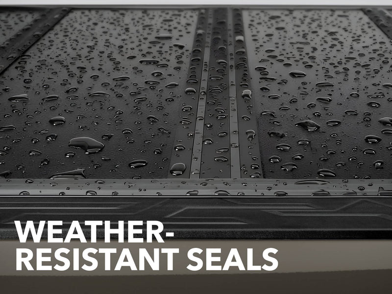 Close-up of the Gator FX tonneau cover: water droplets beading on closed hard cover panels and their seals, captioned Weather-Resistant Seals