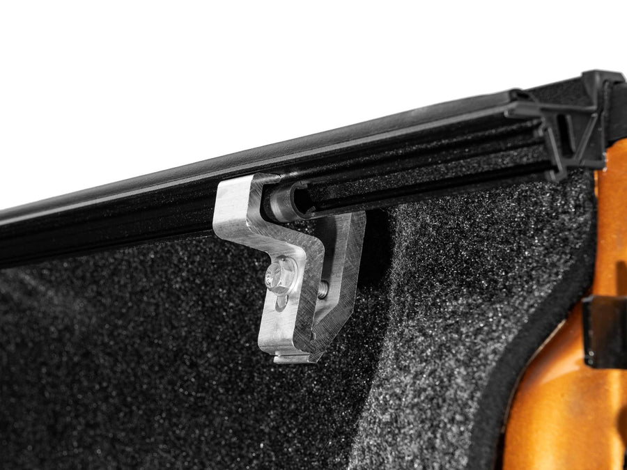 Gator EFX Hard Folding tonneau cover: Close-up of a cover clamp under the side rail over a spray-in bed liner.