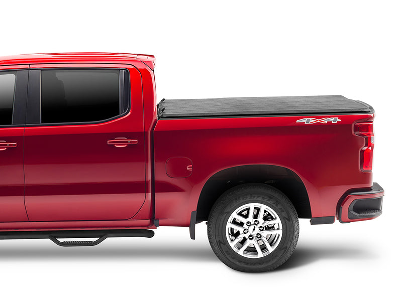 Gator SFX tonneau cover (closed): A red full-size pickup, side view, with a closed black soft tonneau cover