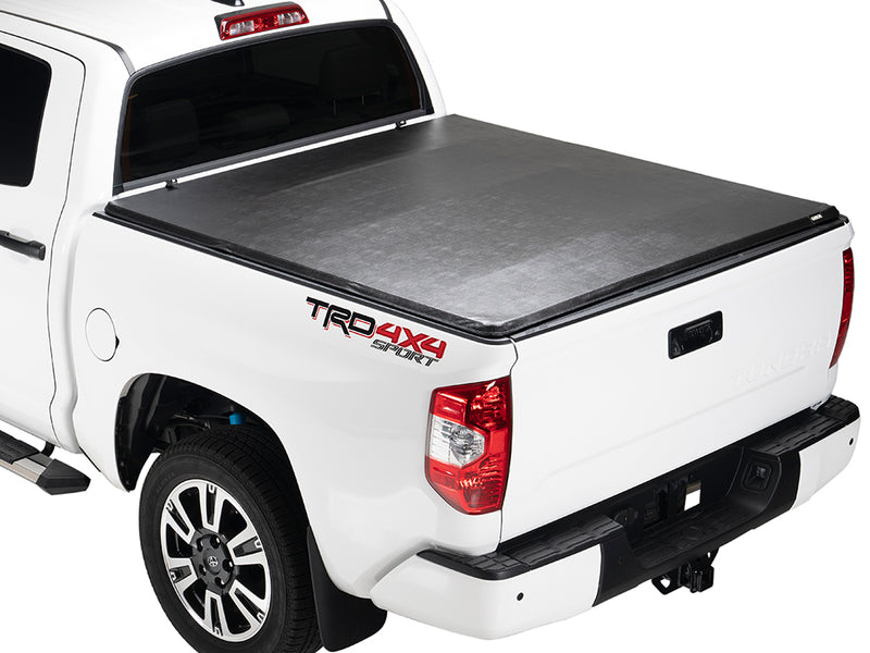 Gator SFX soft tri-fold tonneau cover: closed on a white Toyota pickup, rear three-quarter view