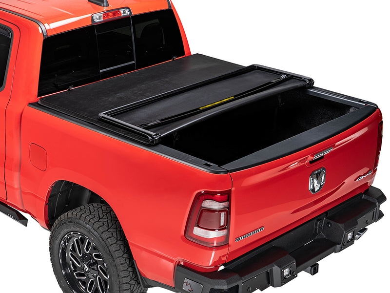 Gator SFX soft tri-fold tonneau cover: folded forward on a red Ram pickup