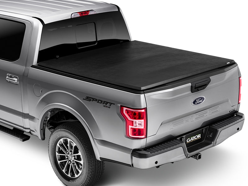 Gator SFX soft tri-fold tonneau cover: closed on a silver Ford pickup, rear three-quarter view