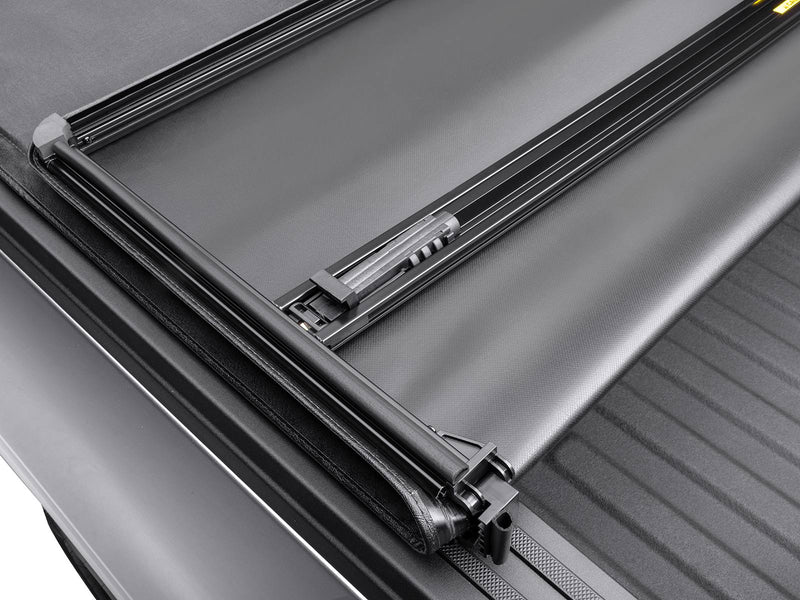Gator SFX soft tri-fold tonneau cover: tri-fold frame and hinge with the rear section folded, close-up