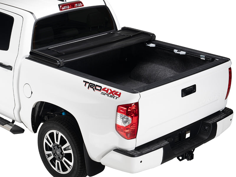 Gator SFX soft tri-fold tonneau cover: folded forward two sections on a white Toyota pickup