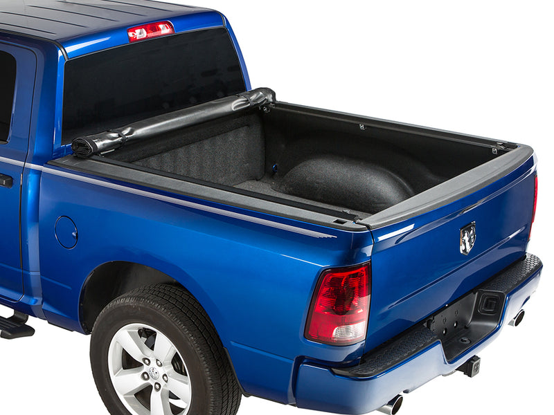 Gator SRX soft roll-up tonneau cover: Blue Ram pickup with a soft roll-up tonneau cover fully rolled against the cab and the bed open