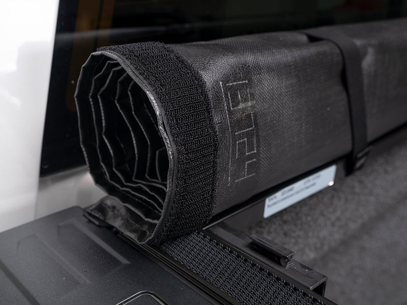 Gator SRX soft roll-up tonneau cover: Close-up of a rolled soft vinyl tonneau cover with its hook-and-loop strap