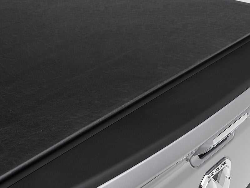 Gator SRX soft roll-up tonneau cover: Close-up of the black vinyl cover edge above a silver tailgate