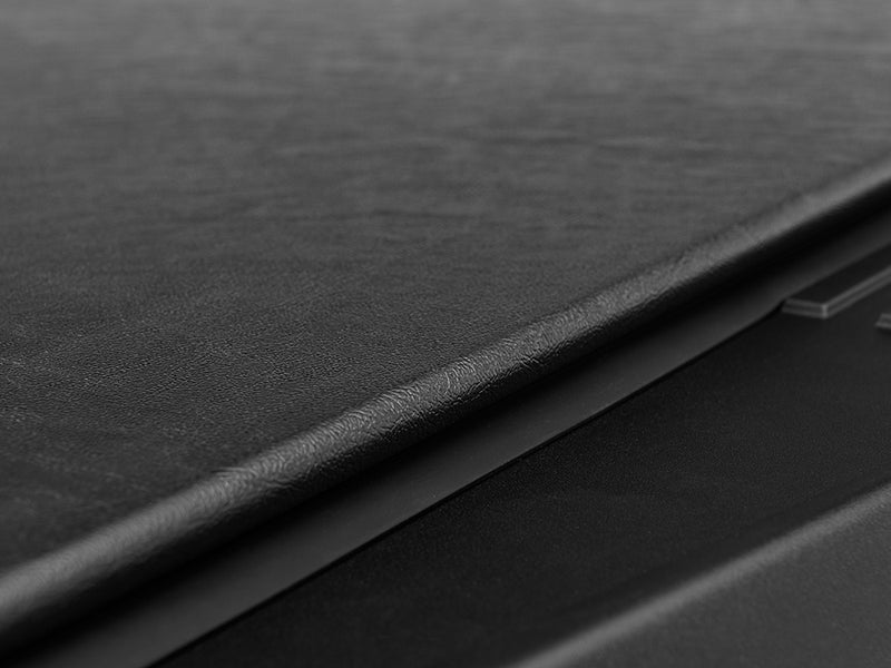 Gator SRX soft roll-up tonneau cover: Close-up of the smooth black vinyl surface and tailgate edge of the closed cover