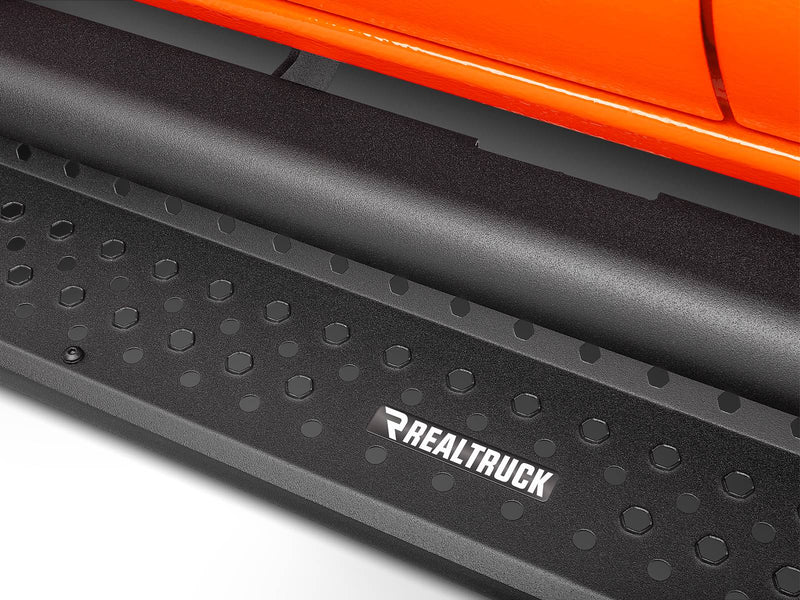 Go Rhino Dominator D1: close-up of a textured black side step tread with hex pattern under an orange body