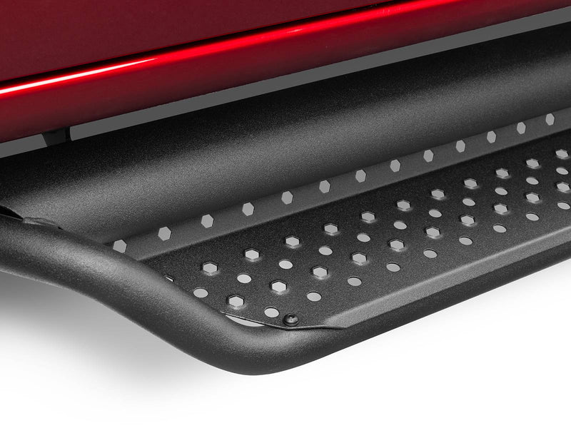 Go Rhino Dominator D1: close-up of the tube end and perforated tread of a black side step under a red body