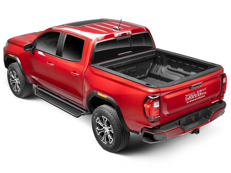 Go Rhino Dominator D1: red GMC Canyon AT4 crew cab from the rear three-quarter with black side steps along the cab