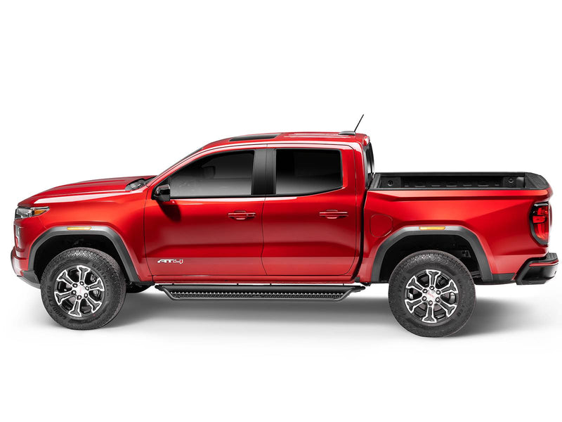 Go Rhino Dominator D1: red GMC Canyon AT4 crew cab in side profile with black side steps along the cab