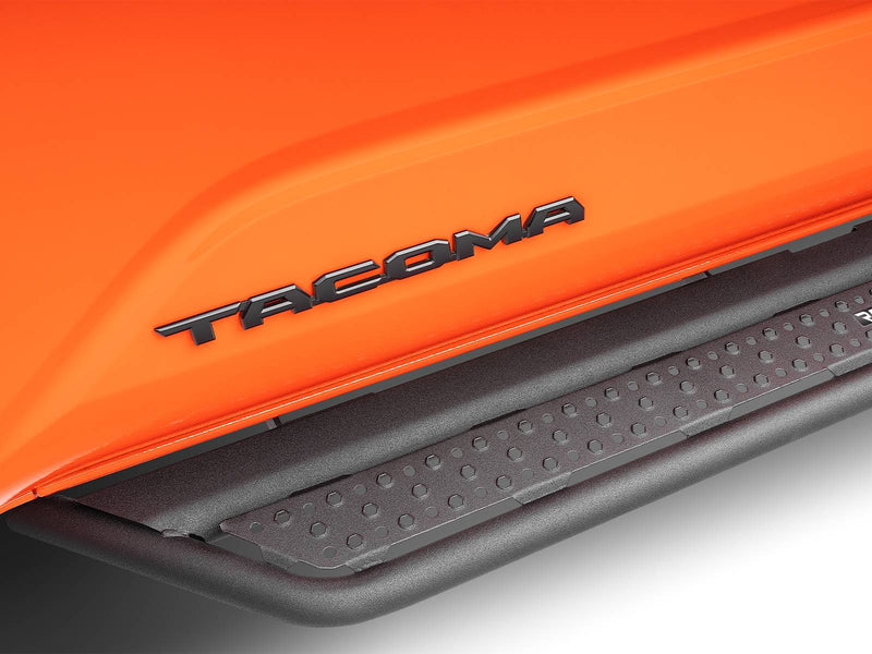 Go Rhino Dominator D6: close-up of a black side step under the TACOMA door lettering of an orange truck