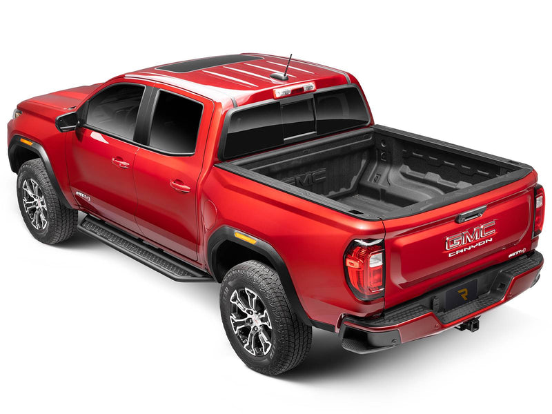 Go Rhino Dominator D6: red GMC Canyon crew cab from the rear three-quarter with black side steps along the cab