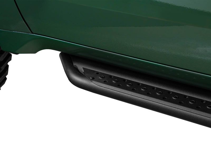 Go Rhino Dominator DSS: black slider board mounted below the door of a dark green truck