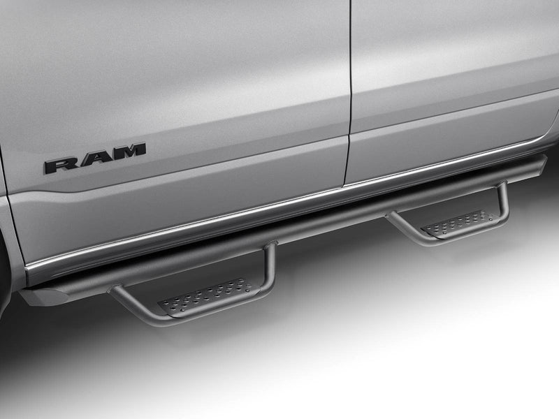 Go Rhino Dominator Xtreme D2: black tube side step with two drop steps mounted under the doors of a silver Ram