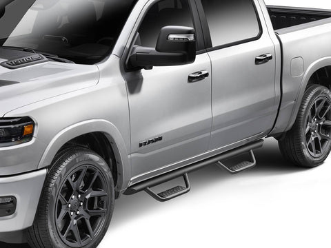 Go Rhino Dominator Xtreme D2: silver crew cab pickup with a black tube side step and drop steps at each door, front three quarter close view