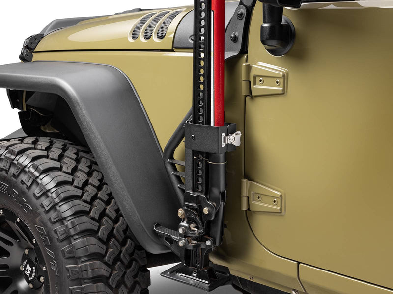 Go Rhino Exterior Jack Mount: black jack mount holding a red farm jack between the fender flare and door of an olive Jeep Wrangler (shown with Hi-Lift style farm jack, not included)