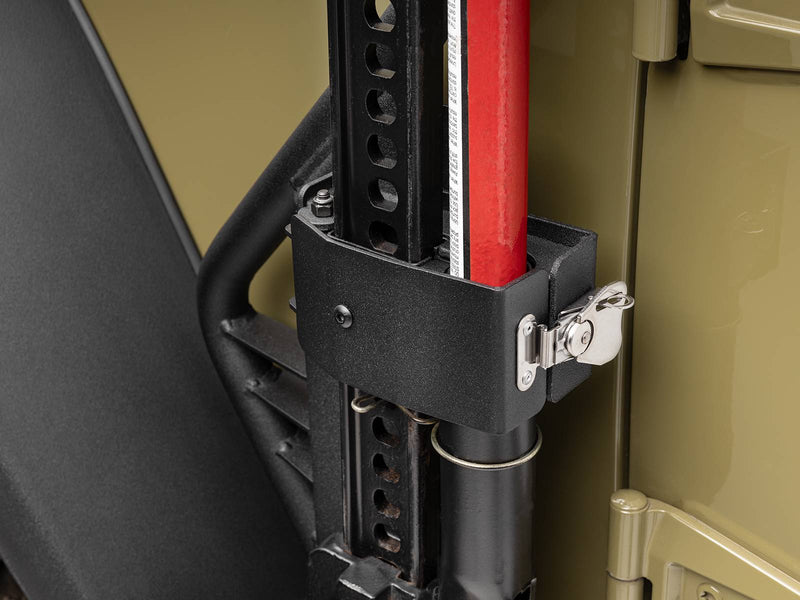 Go Rhino Exterior Jack Mount: close-up of black jack holder with stainless latch clamping a red farm jack at the door hinge (shown with Hi-Lift style farm jack, not included)