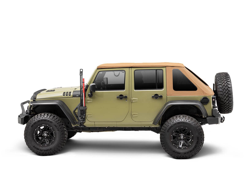 Go Rhino Exterior Jack Mount: side view of an olive four door Jeep Wrangler with tan soft top and a red farm jack held at the front door (shown with Hi-Lift style farm jack, aftermarket bumpers, aftermarket wheels and tires, not included)