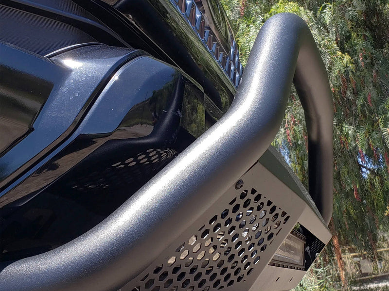 Go Rhino RC4 LR: close-up of a textured black bull bar hoop and hex mesh skid panel on a black vehicle (shown with LED light bar, not included)