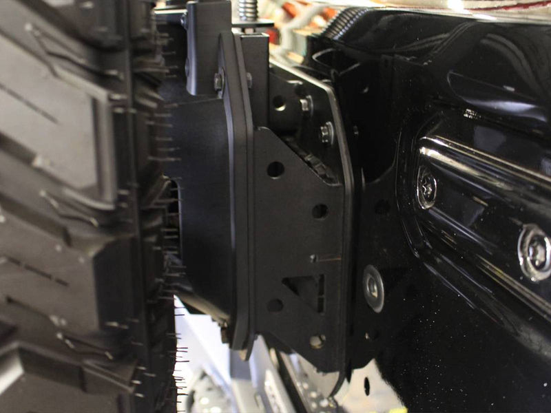 Go Rhino Rockline: close-up of a black relocation bracket bolted to the tailgate hinge area