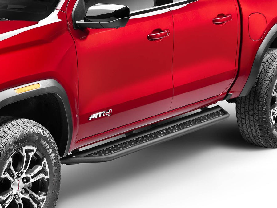 Go Rhino Dominator D6 Running Boards: Black side step under the doors of a red GMC Canyon AT4, front wheel in view