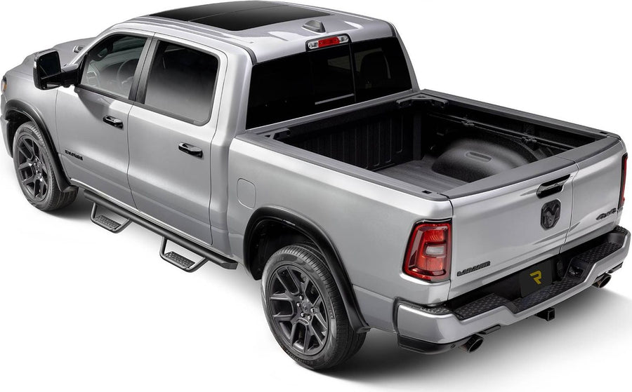 Go Rhino Dominator Xtreme D2 Side Steps: Silver crew cab pickup from the rear three quarter with black tube side steps under the doors