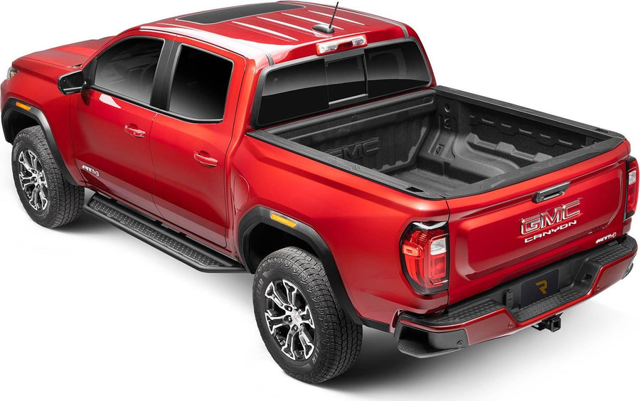 Go Rhino Dominator D6 Running Boards: Red GMC Canyon crew cab from the rear three-quarter with black side steps along the cab