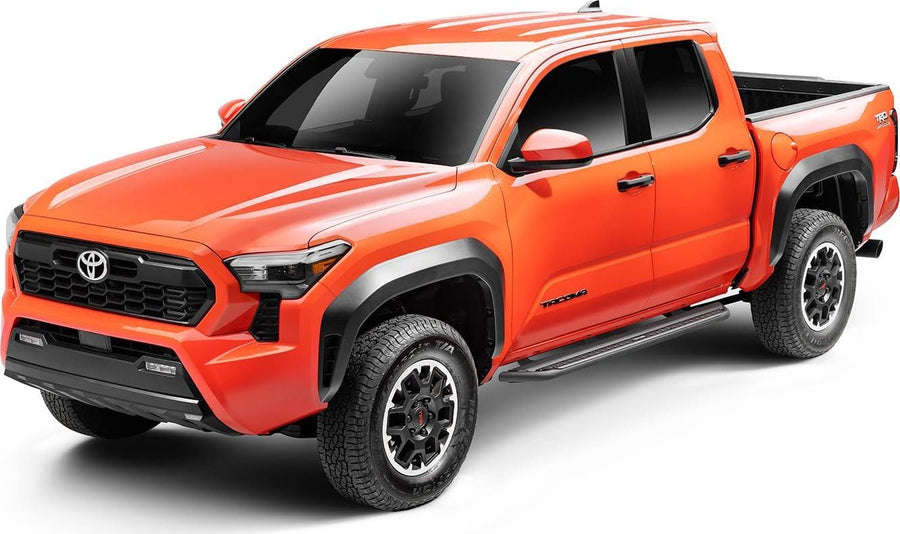 Go Rhino Dominator DSS Sliders: Orange midsize pickup with black slider boards mounted under both doors, front three quarter view