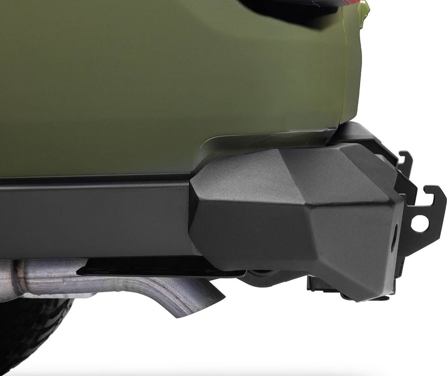 Go Rhino Trailline Full Width Rear Bumper: Rear bumper end with tire carrier tab installed below a green body panel