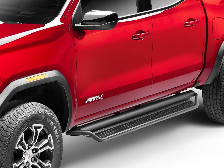 Go Rhino Dominator D1 Side Steps: Black side step under the doors of a red GMC Canyon AT4, front wheel in view