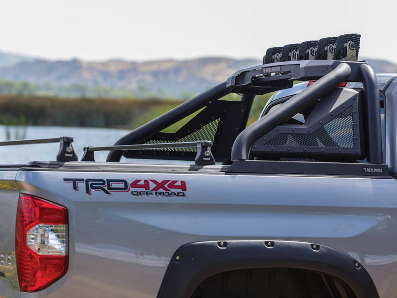 Go Rhino Sport Bar 2.0: black sport bar with mesh panels and LED pods on a silver Toyota pickup with TRD 4x4 decal and crossbars (shown with aftermarket LED light pods on the light mount, Thule crossbars, fender flares, not included)
