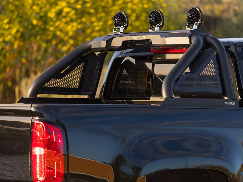 Go Rhino Sport Bar 2.0: black sport bar with mesh side panels and three round lights on a dark blue pickup bed (shown with round light pods, not included)
