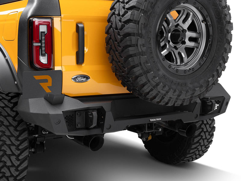 Go Rhino Trailline: rear bumper with hitch receiver installed on an orange Ford Bronco under the spare tire (shown with spare tire, aftermarket wheels, not included)