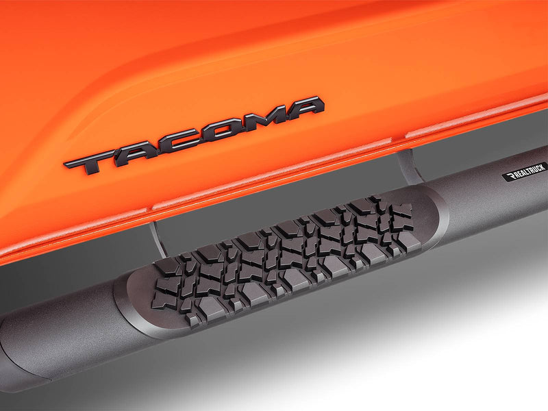 Go Rhino V-Series V3: close-up of the tire-tread step pad and textured black tube under an orange Tacoma door
