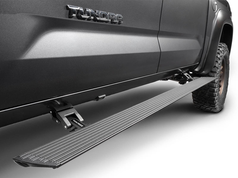 Go Rhino VoltStep: black power running board deployed under the doors of a gray Toyota Tundra (shown with aftermarket wheels and tires, not included)