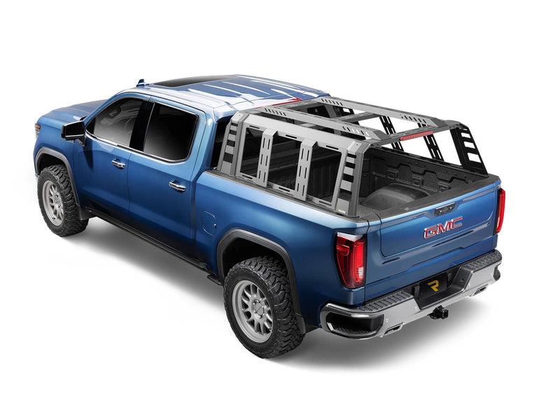 Go Rhino VoltStep: blue GMC Sierra crew cab from the rear three-quarter with a bed rack, running board hidden under the rocker (shown with bed rack, bedliner, aftermarket wheels, not included)