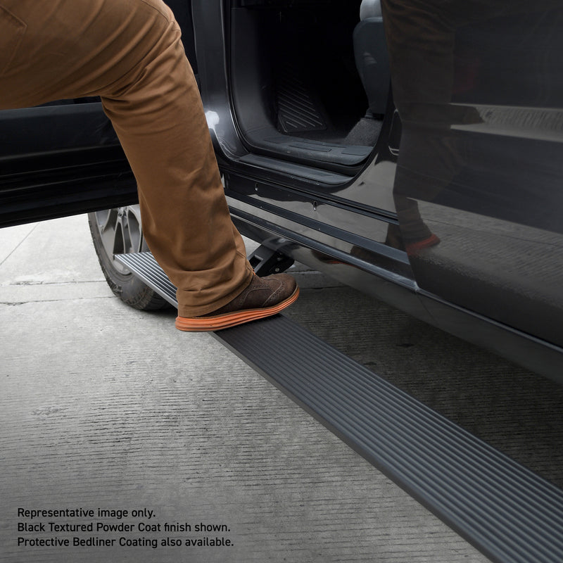 Go Rhino VoltStep: boot stepping onto a deployed black electric running board under an open truck door