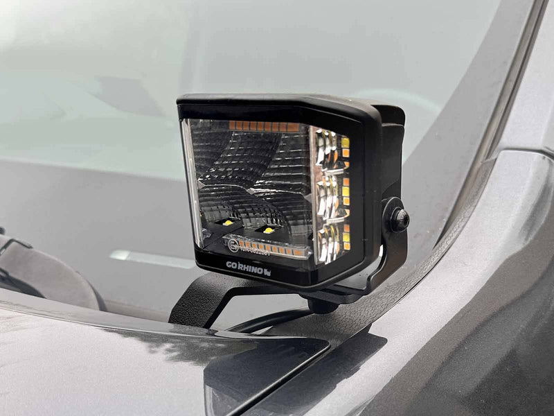 Go Rhino XE: GO RHINO cube light on a black hood bracket at the base of the windshield on a gray hood (shown with LED cube light, not included)