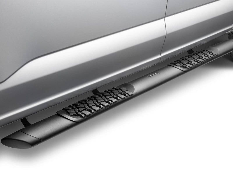 Black side step with a tire-tread pad under the rear door of a silver pickup
