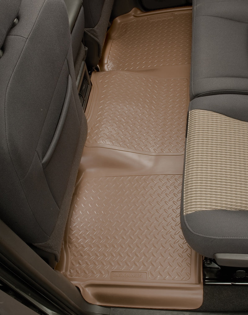 Husky Liners Classic Style: tan diamond-plate one-piece rear floor liner fitted across a pickup rear cab floor