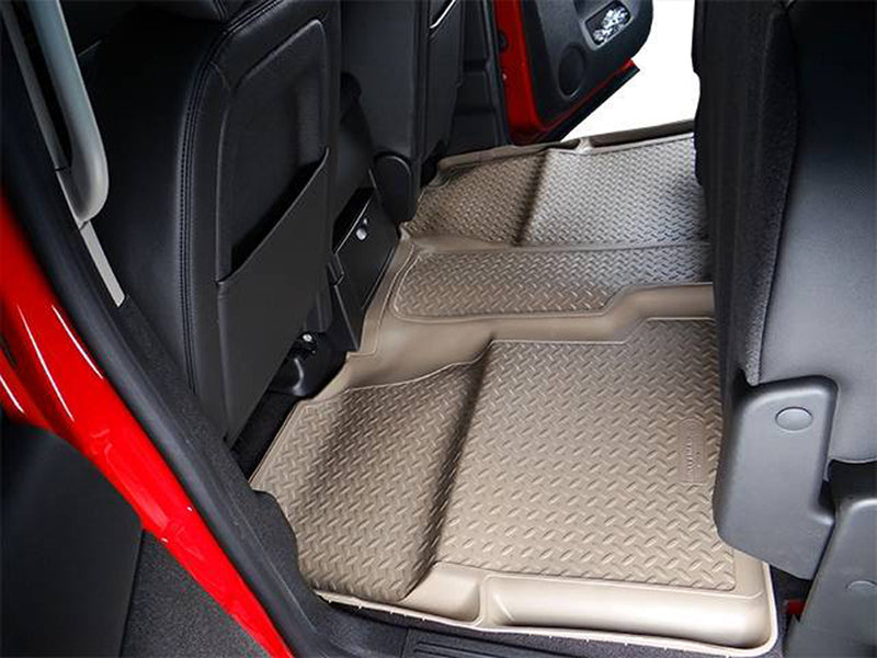 Husky Liners Classic Style: tan one-piece second-row floor liner installed behind the front seats of a crew cab